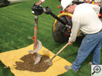 Auguring a hole in the earth for a foundation repair in Kaukauna
