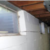 A foundation showing severe inward buckling along the windows in a West Bend home.