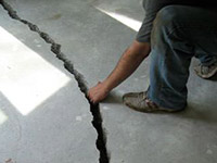 a severely damaged cracked concrete slab floor in Marinette