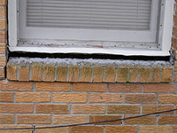 A window sill cracking and separating from the foundation wall in a Two Rivers home.