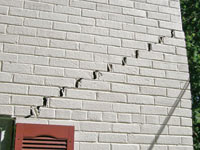 Stair-step cracks showing in a home foundation in Waupaca