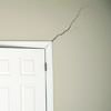 A long drywall crack beginning at the corner of a doorway in a Marinette home.