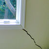 A long, diagonal crack that begins at a window corner of a Shawano home