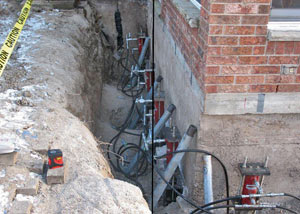 Foundation push piers installed around a house with a foundation settlement issues in Waupun