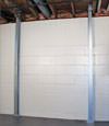 A steel i-beam system installed on a Plover foundation wall