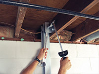 Straightening a foundation wall with the PowerBrace™ i-beam system in a De Pere home.